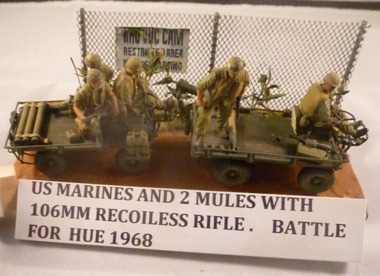 A diorama of US Marines with two mules