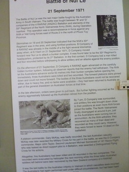 A white board with text and two photographs 1st photo, unidentified soldiers on patrol and Pte Jimmy Duff filling water bottle at stream.