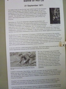 A white board with text and two photographs 1st photo, unidentified soldiers on patrol and Pte Jimmy Duff filling water bottle at stream.