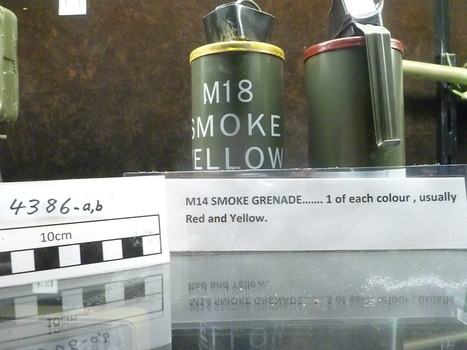 Two smoke cannister, one with yellow top and one with red top. Yellow one has the words M18/Smoke/Yellow