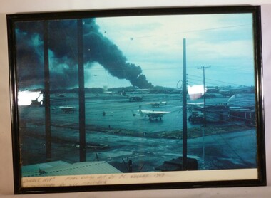 A Framed Coloured Photograph of a Fuel Dump Hit by VC Rocket 1969