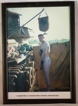 A Framed Coloured Photograph of a Soldier Taking a Shower Beside a Centurion Tank