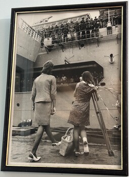 A Framed Black and White Photograph of Two Ladies Farewelling Troops on a Ship