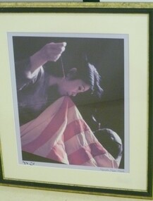Colour Photograph of a Vietnamese Woman Sewing a South Vietnamese Flag.