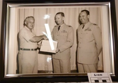 Black and White photo in black and white frame of SQN LDR Alan Reed receiving a citation to accompany Distinguished Flying Cross