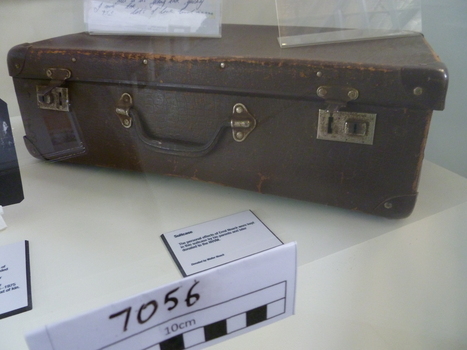 Brown card board small case that with carry handle and locking catches.