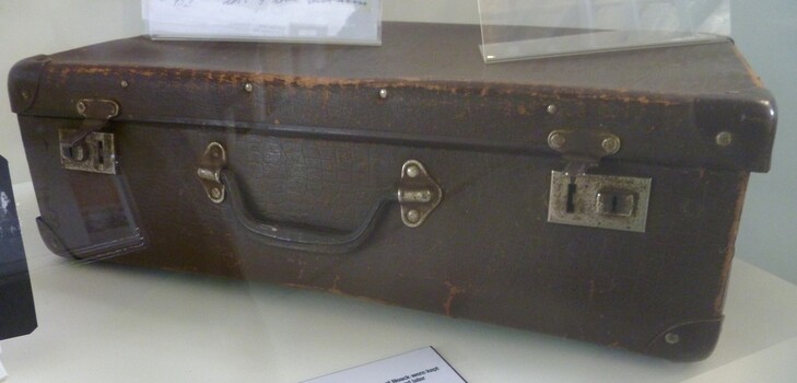 Brown card board small case that with carry handle and locking catches.