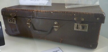 Brown card board small case that with carry handle and locking catches.