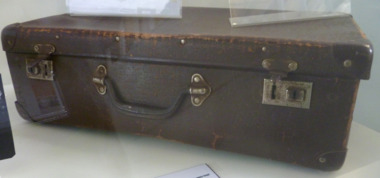 Brown card board small case that with carry handle and locking catches.