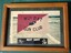Small coloured phott of a sign with the word Nui Dat Gun  Club
