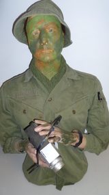 Top half life-sized mannequin of a soldier in jungle greens shirt, hat, scarf watch, two pens in pocket