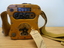 Squat yellow transmitter used in emergency life rafts carried by aircraft on flights over water. Shape enabled it to be held between knees. 