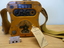Squat yellow transmitter used in emergency life rafts carried by aircraft on flights over water. Shape enabled it to be held between knees. 