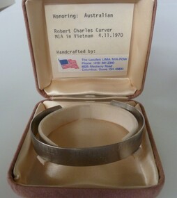 Stainless steel open-ended bracelet engraved with missing serviceman's full name and date missing.