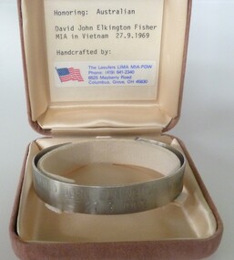 Stainless steel open-ended bracelet engraved with missing serviceman's full name and date missing. In a buff square velvet satin-lined box.