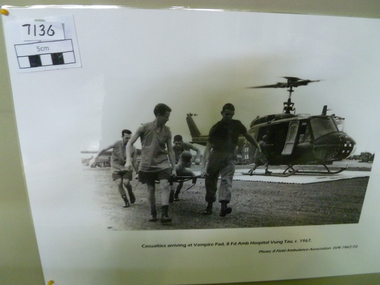 Photograph, Casualties Arriving Vampire Pad 8 FD Amb