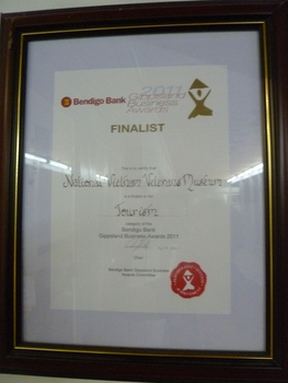 Brown stained wooden frame with gold trim. Bendigo Bak 2011 Gippsland Business Awards. Finalist Tourism.