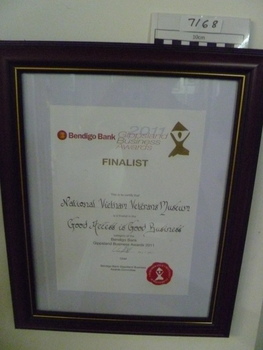 Brown, stained wooden frame with gold trim. Finalist, 2011 "Good Access is Good Business" category.