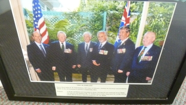 A Black Framed Coloured Photograph of Bayne (Gus) Kelly receiving US Commendation Medal - September 2011