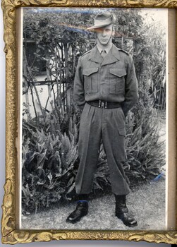 A framed photograph of Private Errol Noack in uniform in front of a garden taken at his home in Adelaide his deployment to Vietnam.