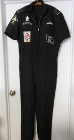 A black one piece Dining Suit (party suit)  with zippered front and pockets, bearing Squadron Leader epaulettes