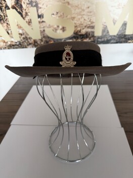 Grey fur felt Akubra made in 1969, has a black hat band with the siler and red badge of the RAAN on the front