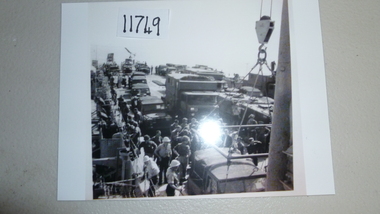 Photograph, Electric crane unloading cargo onto landing barge