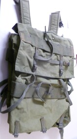 Army khaki canvas backpack and webbing outside camouflage plastic lined