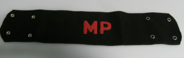 Black material with four press studs on back and red MP machine embroidered on front