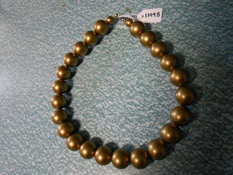 Necklace made of gold coloured beads threaded on strong cotton with brass catch.