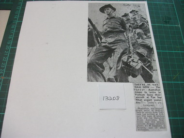 Copy of a newspaper cutting. Picture of Soldiers with full military equipment disembarking their aircraft to start their Tour in Vietnam. 