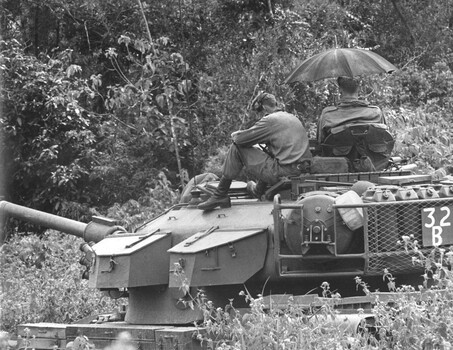 A black and white photograph of a Centurian Tank of 1st Armoured Regt is stopped during a lull in fighting awaiting orders to move