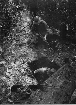 A photograph of Engineers checking out enemy bunkers and tunnels prior to setting explosives and cs crystals to destroy and impregnate the system of tunnels