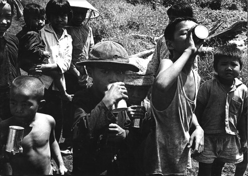 A photograp of Children of Xuyen Moc enjoy chilled flavoured milk given to them by members of 161 (Indep)  Recce Flt  by 5 RAR.