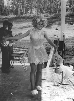 A photograph of musicians with the Sep-Oct 67 Official Melbourne Concert Party appreciate Denise 'Ding Dong" Drysdale's Alice in Wonderlad act. 