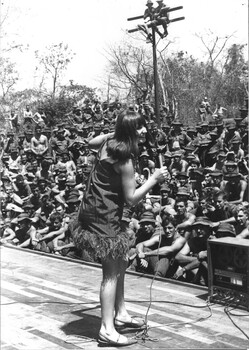 A photograph - Dinah Lee has the main body of the diggers enthralled with her presentation of 'Hey Yokomo' at 1st ATF Base Nui Dat.