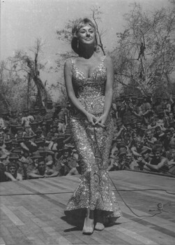 A black and white photograph of Lorrae Desmond entertains the diggers from the back of a flat bed trailer used as a stage 