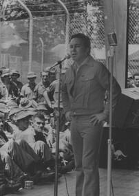 A photograph of Johnny O'Keefe sings before appreciative diggers. O'Keefe with Caroline Page and The Playboys on August 1969 at Nui Dat 