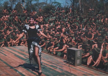 A photograph of Jackie De Paul a specialty dancer with the March - April 1967 Sydney ABC Show entertains diggers of 1st ATF Nui Dat