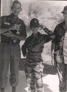 A photograph of Maj Lorrae Desmond in a camoflague 'tiger suit' wearing the ATF's US Army Air Ops Liason officer Maj Bob Mew's hat.