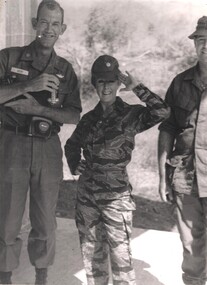 A photograph of Maj Lorrae Desmond in a camoflague 'tiger suit' wearing the ATF's US Army Air Ops Liason officer Maj Bob Mew's hat.