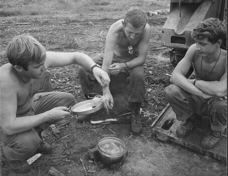 A photograph after fishing boats were seized, members of Normie's APC Troop enjoy an evening meal of fresh prawns and seafood. 