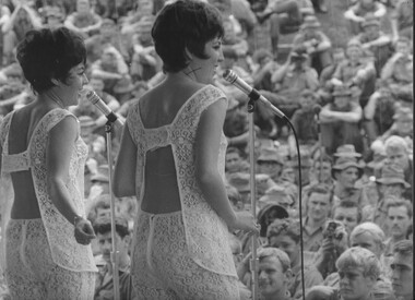 A photograph of The Wills Sisters, Anne and Susan entertain Diggers as part of the Official Sep-Oct 69 Lorrae Desmond Show in a monsoonal downpour