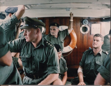 A photograph of soldiers on a Landing Craft along the banks of the Mekong River whilst ferrying supplies to the ARVN at Long Binh. 