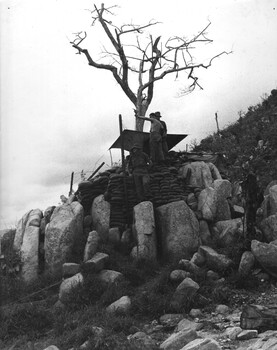 A photograph of 7 RAR diggers man an observation post at the 'Horseshoe Feature' lookout over the known infiltration route used by NVA/VC. 