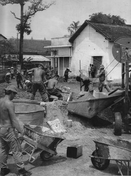 A photograph of Engineers and Diggers from the 1st Australian Civil Affairs Unit make repairs and refurbish the dispensary and hospital at Hoa Long. 