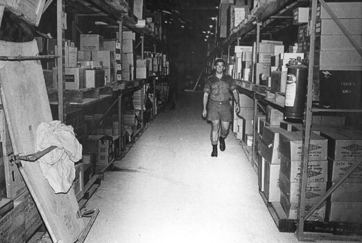 A photograph of Corporal Storeman and an Assistant are kept busy checking and issuing stores from the Quartermasters Store at 1st Australian Field Hospital. 