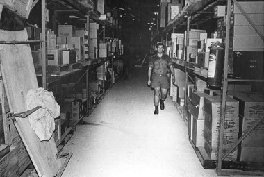 A photograph of Corporal Storeman and an Assistant are kept busy checking and issuing stores from the Quartermasters Store at 1st Australian Field Hospital. 