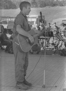 Trooper Normie Rowe in the field entertains the 4th Battalion, RAR/NZ (ANZAC) as a special guest artist at their owned produced farewell concert.  