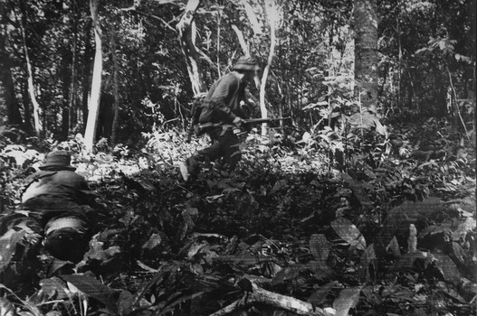 A photograph of 1ATF during 'Operation Atherton' 10 December 1969.  1 Platoon, A Company, 8 RAR diggers under heavy machin gun, 